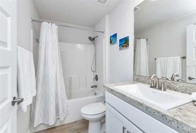 7664 Meroni Blvd, North Port, FL 34291 - bathroom featuring shower / tub combo, vanity, toilet, and wood finished floors
