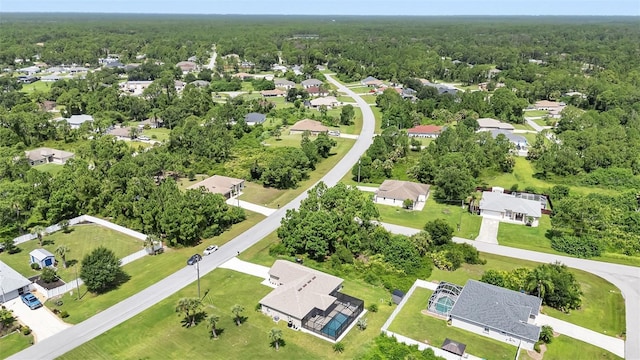 7664 Meroni Blvd, North Port, FL 34291 - aerial view of property and surrounding area featuring nearby suburban area and a heavily wooded area