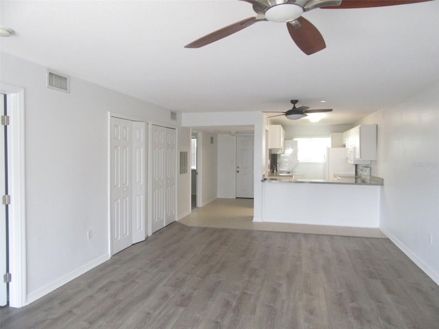 150 Harborside Ave Unit 124, Punta Gorda, FL 33950 - unfurnished living room featuring light wood finished floors, a ceiling fan, and baseboards