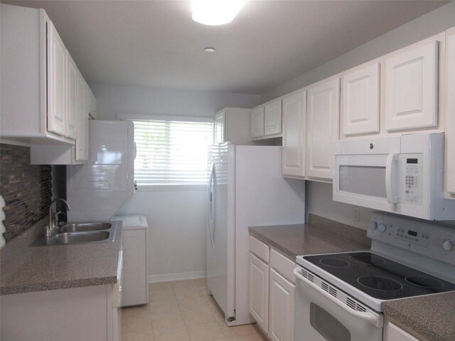 150 Harborside Ave Unit 124, Punta Gorda, FL 33950 - kitchen with white appliances, a sink, tasteful backsplash, and white cabinets