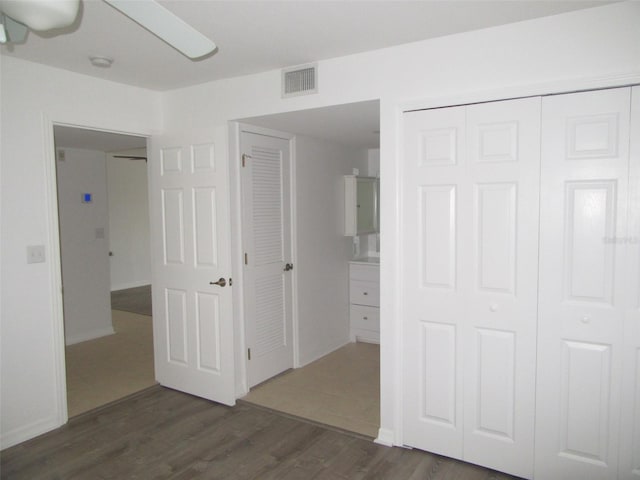 150 Harborside Ave Unit 124, Punta Gorda, FL 33950 - unfurnished bedroom featuring wood finished floors, a closet, and baseboards