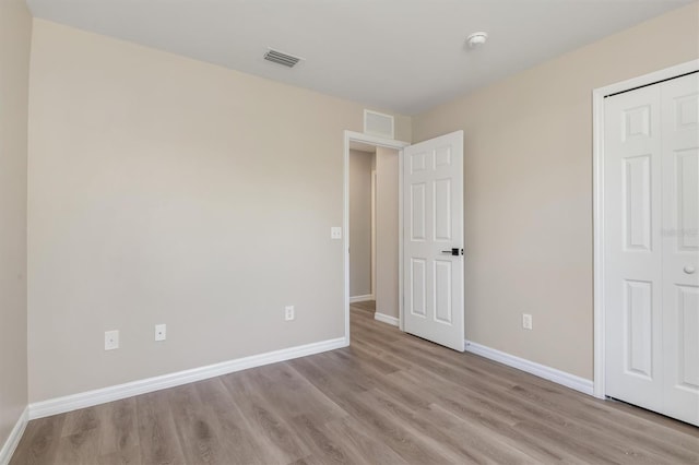2381 Sheila Ln, North Port, FL 34286 - unfurnished bedroom with light wood-type flooring, baseboards, and a closet