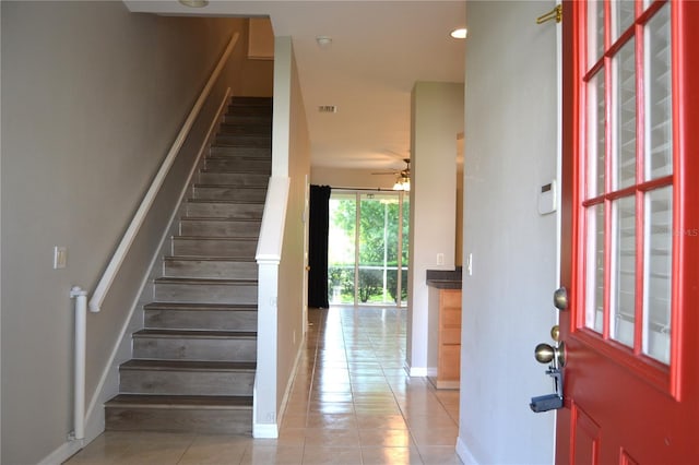 1271 Jonah Dr, North Port, FL 34289 - entrance foyer featuring stairs, light tile patterned floors, and a ceiling fan
