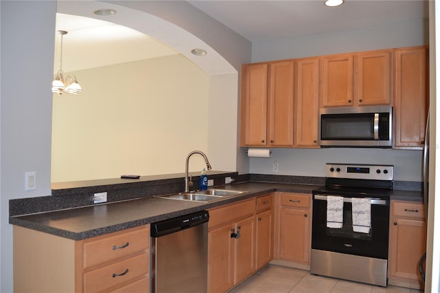 1271 Jonah Dr, North Port, FL 34289 - kitchen featuring appliances with stainless steel finishes, dark countertops, light tile patterned flooring, pendant lighting, and recessed lighting