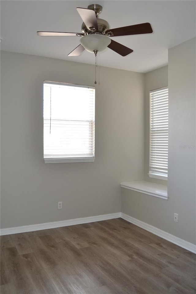1271 Jonah Dr, North Port, FL 34289 - empty room with plenty of natural light, wood finished floors, and ceiling fan