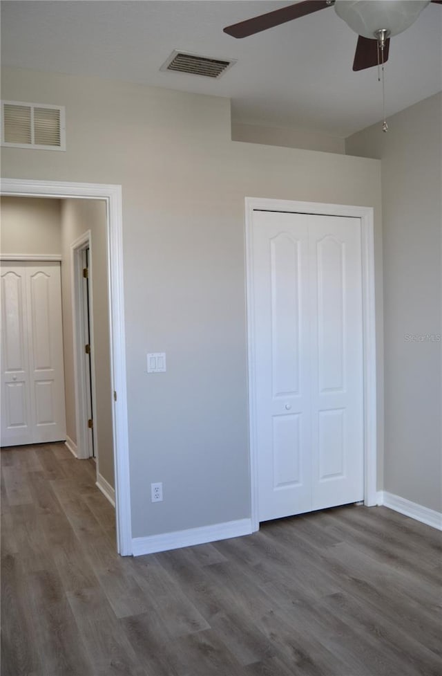 1271 Jonah Dr, North Port, FL 34289 - unfurnished bedroom with wood finished floors, a closet, and a ceiling fan