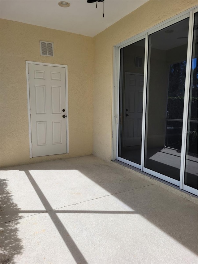 1271 Jonah Dr, North Port, FL 34289 - entrance to property with stucco siding, a patio, and a ceiling fan