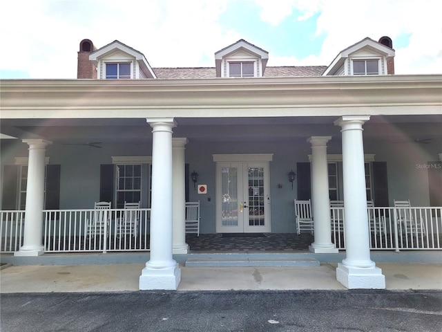 1271 Jonah Dr, North Port, FL 34289 - view of exterior entry featuring french doors and a porch