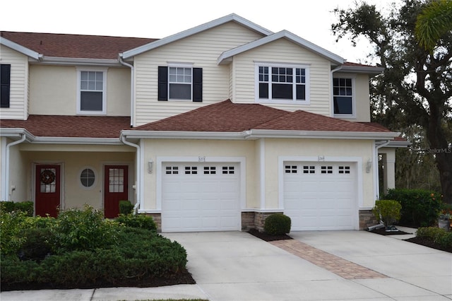 1271 Jonah Dr, North Port, FL 34289 - view of front of home with concrete driveway, a shingled roof, an attached garage, and stucco siding