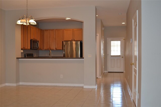 1271 Jonah Dr, North Port, FL 34289 - kitchen featuring stainless steel appliances, a chandelier, arched walkways, dark countertops, and recessed lighting