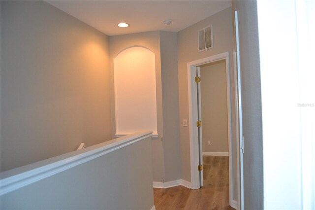 1271 Jonah Dr, North Port, FL 34289 - corridor with light wood-style floors, recessed lighting, arched walkways, and an upstairs landing