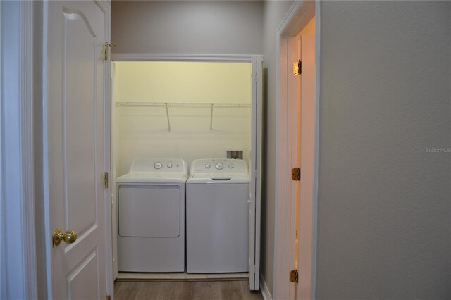 1271 Jonah Dr, North Port, FL 34289 - laundry room featuring independent washer and dryer and wood finished floors