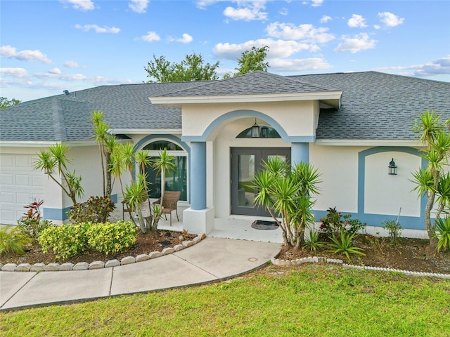 1 Sportsman Way, Rotonda West, FL 33947 - view of front facade featuring a shingled roof, a garage, and a porch