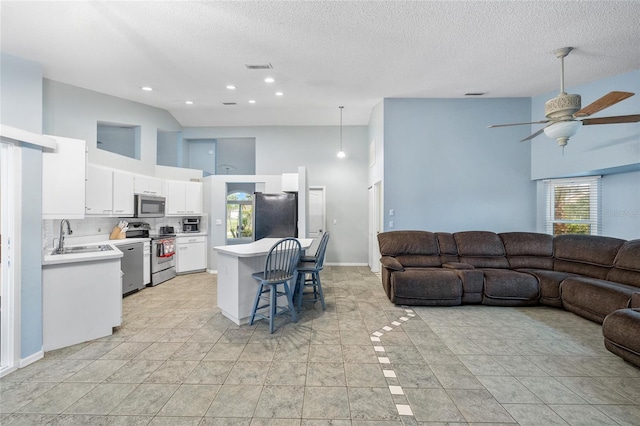 1 Sportsman Way, Rotonda West, FL 33947 - living area with high vaulted ceiling, ceiling fan, a textured ceiling, recessed lighting, and light tile patterned floors