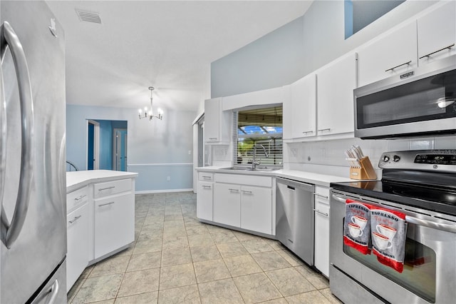 1 Sportsman Way, Rotonda West, FL 33947 - kitchen featuring appliances with stainless steel finishes, a sink, a chandelier, light countertops, and decorative backsplash