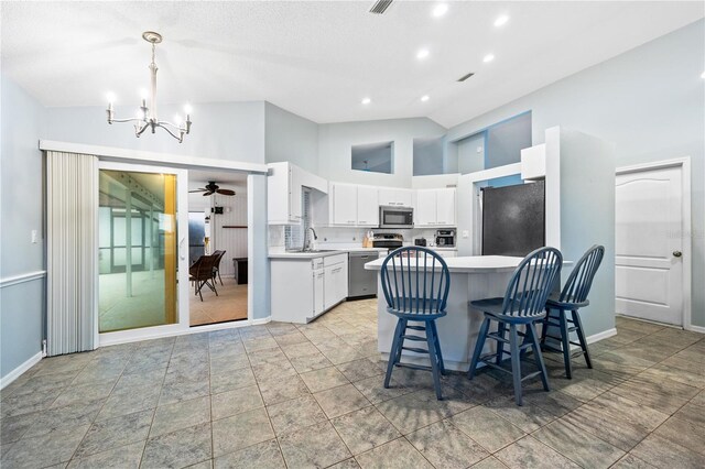 1 Sportsman Way, Rotonda West, FL 33947 - kitchen featuring stainless steel appliances, a chandelier, light countertops, a sink, and white cabinetry