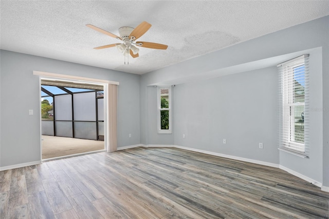 1 Sportsman Way, Rotonda West, FL 33947 - unfurnished room featuring a ceiling fan, wood finished floors, a textured ceiling, and baseboards