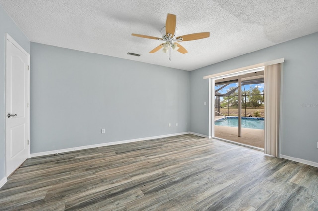 1 Sportsman Way, Rotonda West, FL 33947 - spare room featuring a ceiling fan, wood finished floors, a textured ceiling, and baseboards