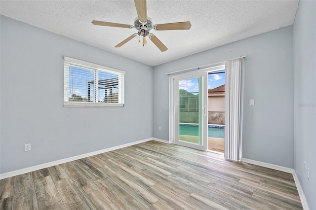 1 Sportsman Way, Rotonda West, FL 33947 - spare room featuring wood finished floors, a textured ceiling, baseboards, and ceiling fan