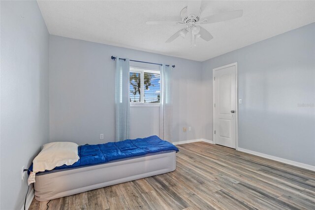 1 Sportsman Way, Rotonda West, FL 33947 - bedroom with wood finished floors, baseboards, and ceiling fan