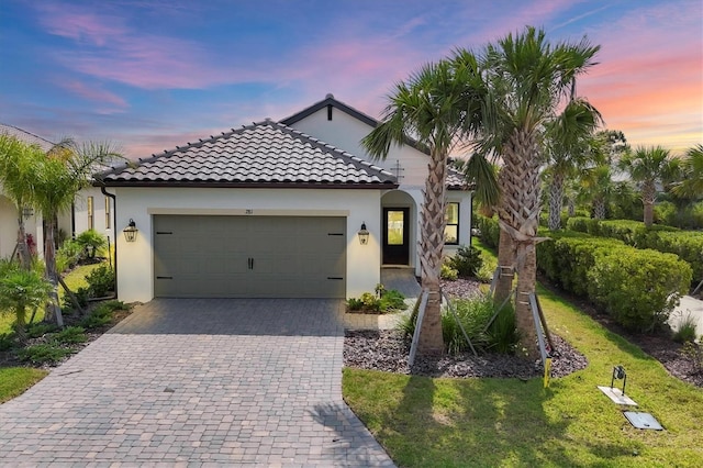 281 Potenza Loop, Nokomis, FL 34275 - mediterranean / spanish home with a garage, stucco siding, decorative driveway, and a tile roof