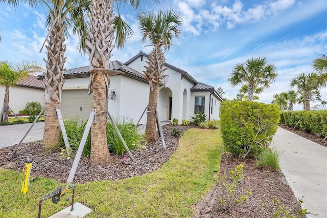 281 Potenza Loop, Nokomis, FL 34275 - view of front of property featuring a garage, stucco siding, a tile roof, and driveway