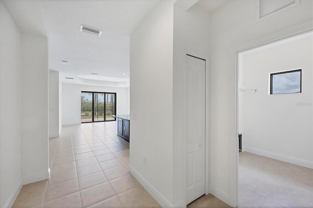 281 Potenza Loop, Nokomis, FL 34275 - corridor featuring light tile patterned floors and baseboards