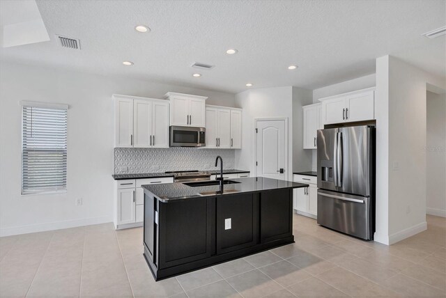 281 Potenza Loop, Nokomis, FL 34275 - kitchen featuring appliances with stainless steel finishes, dark countertops, backsplash, white cabinets, and recessed lighting