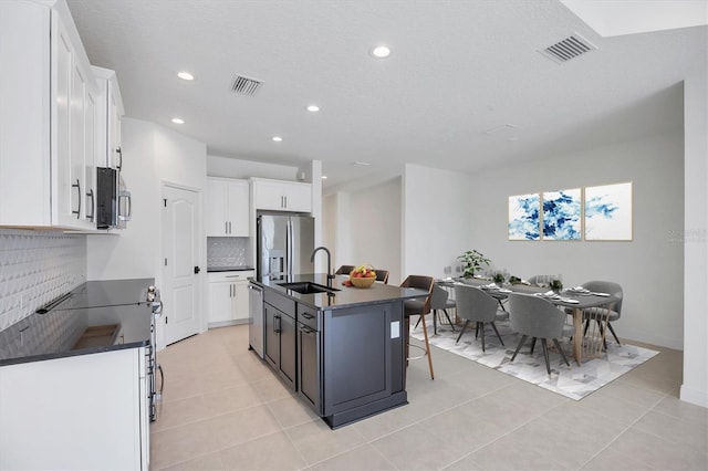 281 Potenza Loop, Nokomis, FL 34275 - kitchen with dark countertops, stainless steel appliances, a sink, tasteful backsplash, and recessed lighting