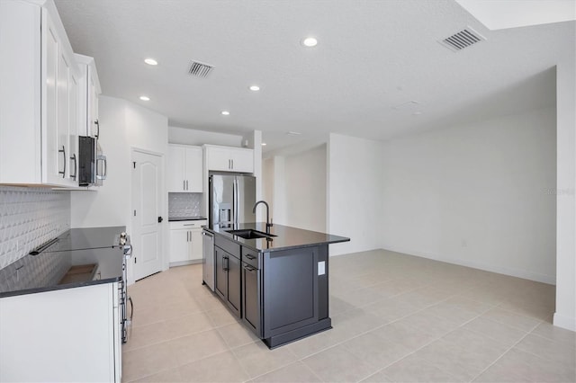 281 Potenza Loop, Nokomis, FL 34275 - kitchen featuring dark countertops, stainless steel appliances, a sink, decorative backsplash, and recessed lighting