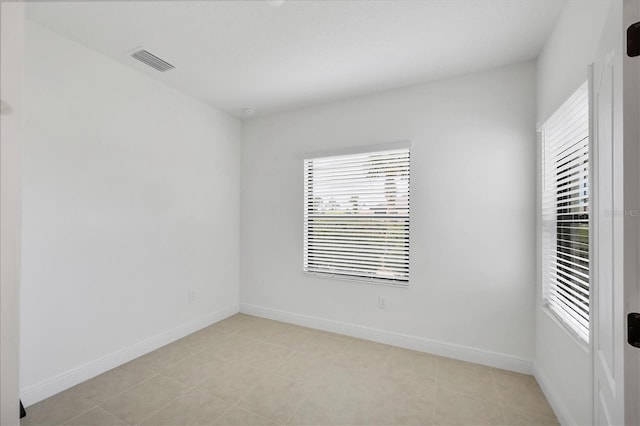 281 Potenza Loop, Nokomis, FL 34275 - empty room with plenty of natural light, baseboards, and light tile patterned flooring