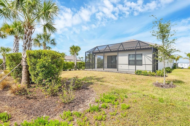 281 Potenza Loop, Nokomis, FL 34275 - rear view of house featuring a yard, glass enclosure, and stucco siding