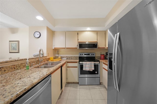 19505 Quesada Ave Unit M104, Port Charlotte, FL 33948 - kitchen featuring stainless steel appliances, a sink, cream cabinets, light tile patterned floors, and recessed lighting