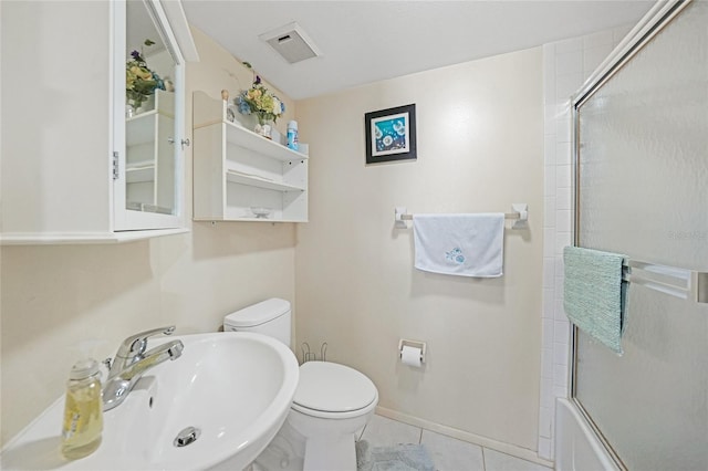 19505 Quesada Ave Unit M104, Port Charlotte, FL 33948 - full bathroom featuring a sink, toilet, tile patterned floors, and enclosed tub / shower combo