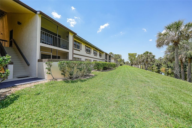 19505 Quesada Ave Unit M104, Port Charlotte, FL 33948 - view of grassy yard with stairway