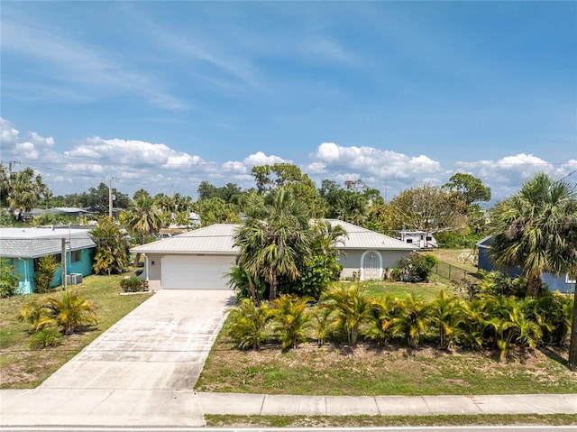 2008 Pellam Blvd, Port Charlotte, FL 33948 - view of front of house featuring driveway, stucco siding, and metal roof