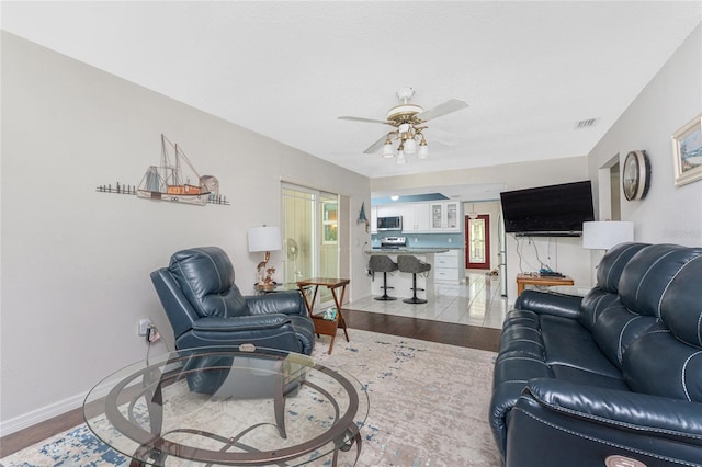 2008 Pellam Blvd, Port Charlotte, FL 33948 - living area featuring wood finished floors, ceiling fan, and baseboards