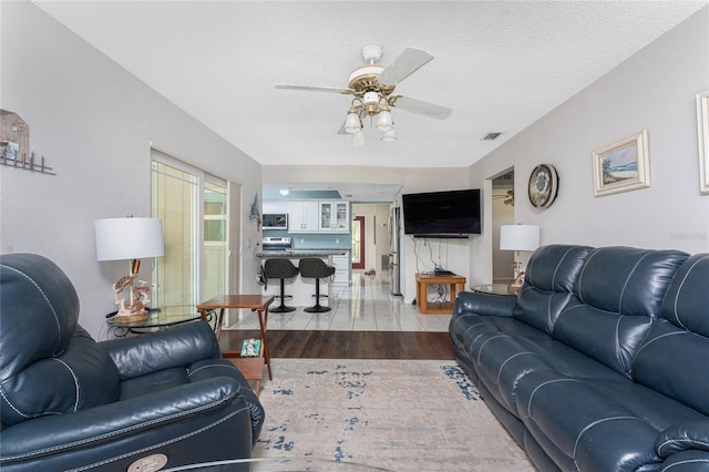 2008 Pellam Blvd, Port Charlotte, FL 33948 - living area featuring ceiling fan, a textured ceiling, and wood finished floors