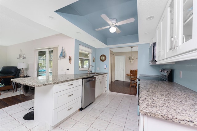 2008 Pellam Blvd, Port Charlotte, FL 33948 - kitchen featuring appliances with stainless steel finishes, light tile patterned floors, white cabinets, and light stone counters