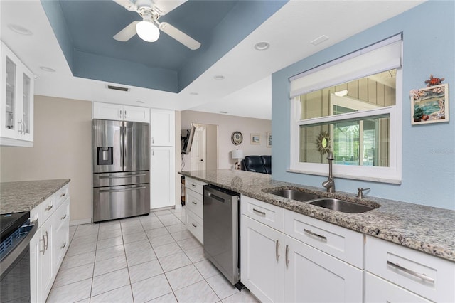 2008 Pellam Blvd, Port Charlotte, FL 33948 - kitchen featuring appliances with stainless steel finishes, a sink, light stone countertops, and white cabinets