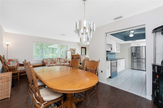 2008 Pellam Blvd, Port Charlotte, FL 33948 - dining space with a chandelier, light wood-style flooring, ceiling fan, and a textured ceiling