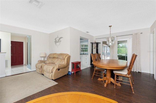 2008 Pellam Blvd, Port Charlotte, FL 33948 - dining space featuring a chandelier, wood finished floors, and baseboards