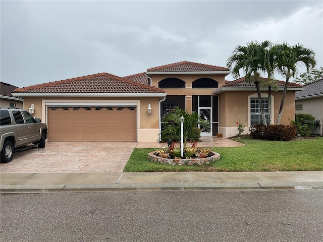 1961 Palo Duro Blvd, North Fort Myers, FL 33917 - mediterranean / spanish house featuring a garage, a front yard, and stucco siding