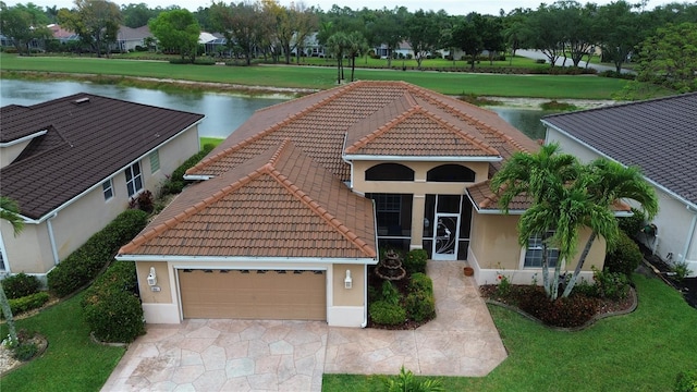 1961 Palo Duro Blvd, North Fort Myers, FL 33917 - view of front facade featuring a tile roof, a water view, and a front lawn