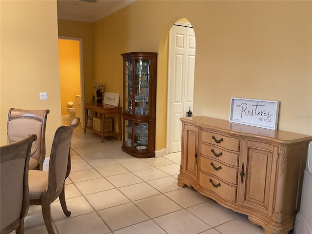 1961 Palo Duro Blvd, North Fort Myers, FL 33917 - dining room with light tile patterned floors, arched walkways, and crown molding