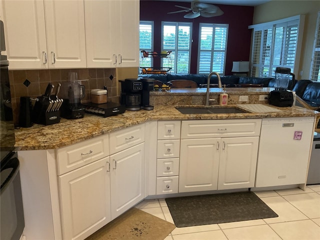 1961 Palo Duro Blvd, North Fort Myers, FL 33917 - kitchen featuring a sink, white cabinets, decorative backsplash, and a peninsula