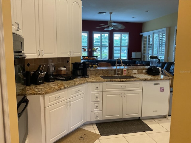 1961 Palo Duro Blvd, North Fort Myers, FL 33917 - kitchen with a sink, a peninsula, ceiling fan, and white cabinets