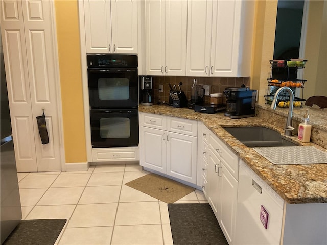 1961 Palo Duro Blvd, North Fort Myers, FL 33917 - kitchen featuring a sink, light tile patterned flooring, dishwasher, white cabinets, and stone counters