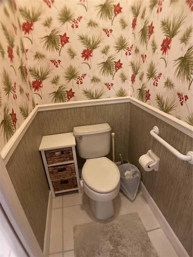 1961 Palo Duro Blvd, North Fort Myers, FL 33917 - bathroom with wallpapered walls, tile patterned flooring, toilet, and a wainscoted wall