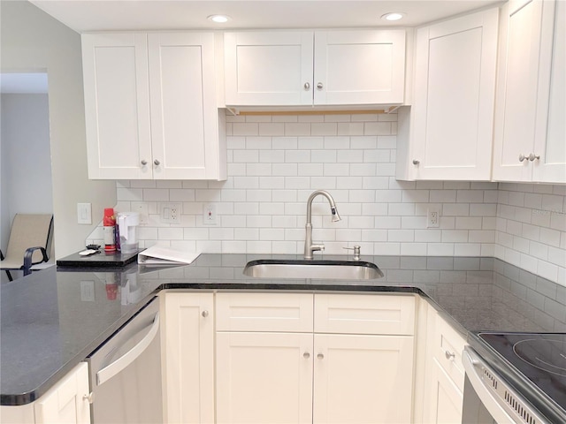 4158 Tamiami Trl Unit A5, Port Charlotte, FL 33952 - kitchen with a sink, stainless steel appliances, white cabinetry, tasteful backsplash, and recessed lighting